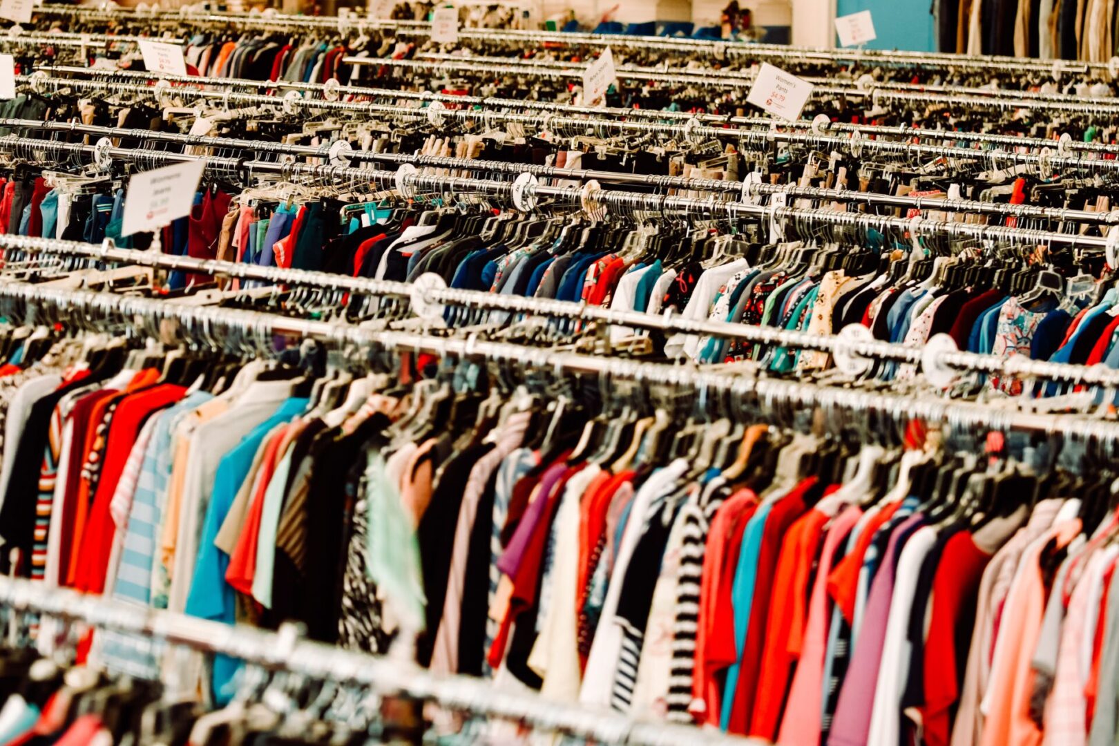 A large amount of clothes are on the racks.