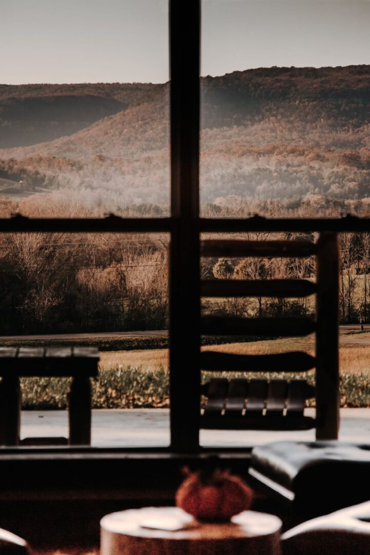 A bench and table in front of a window.