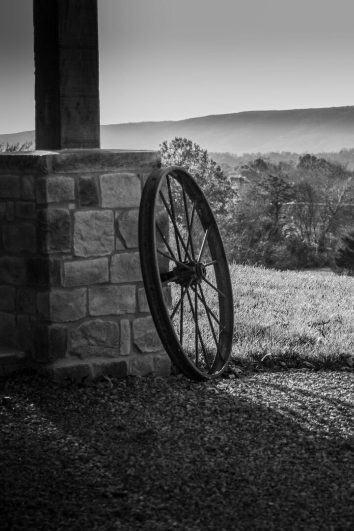 A black and white photo of an old wheel