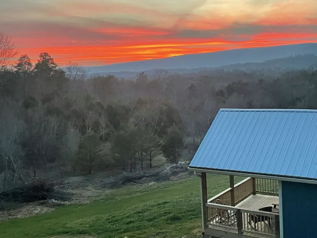 A view of the sunset from a cabin in the mountains.